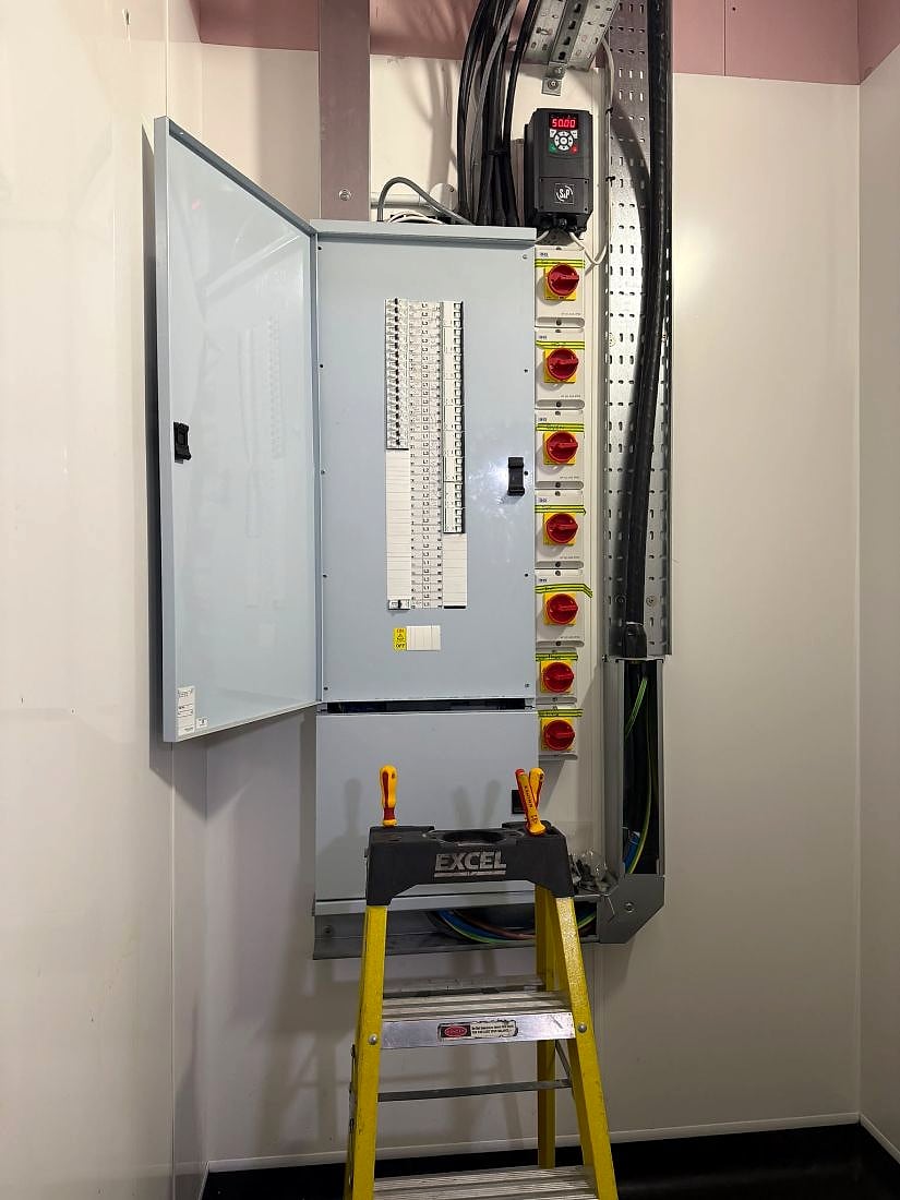 A three-phase distribution board in a commercial unit, opened for fixed wire testing